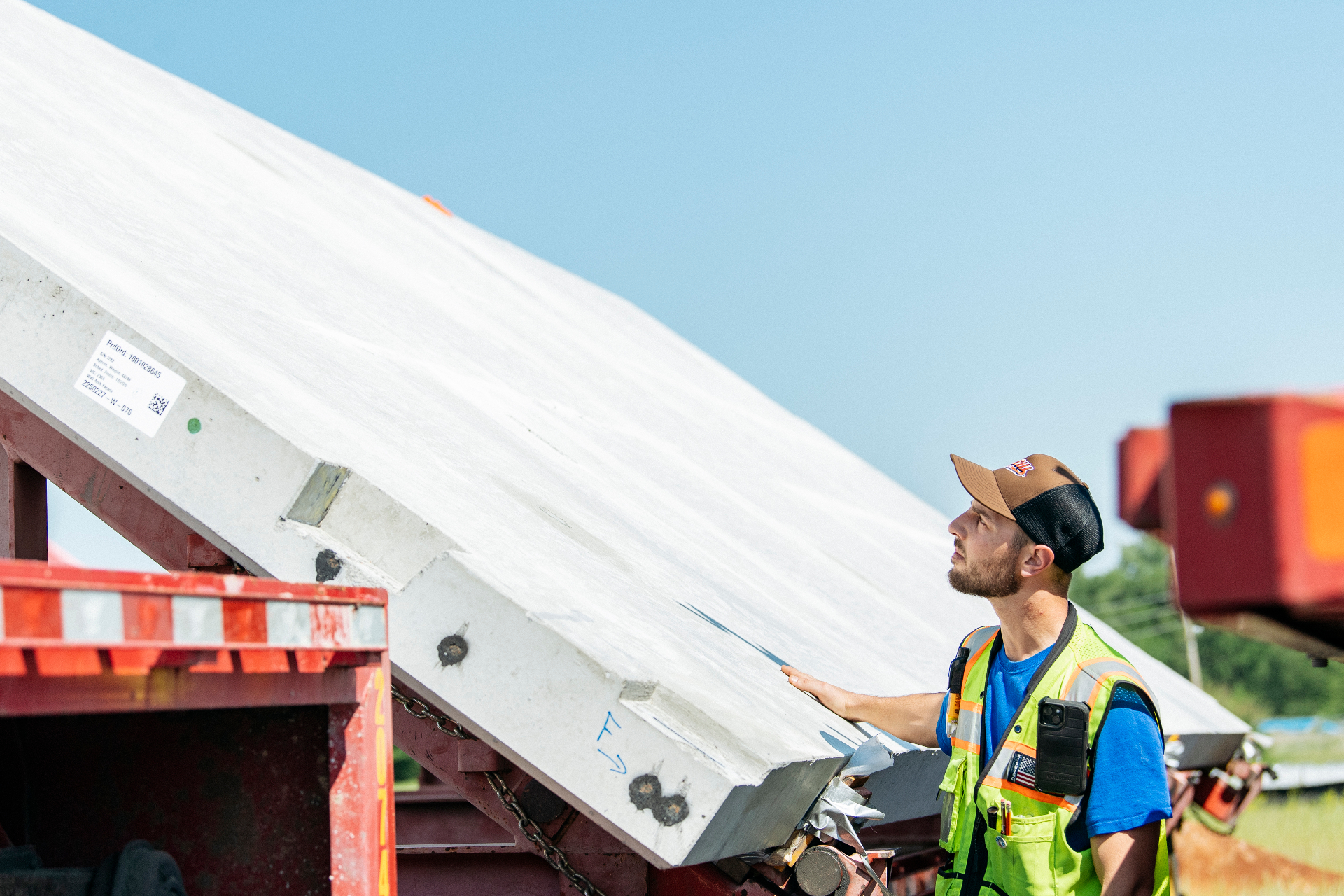 Construction worker inspecting a large panel on site.